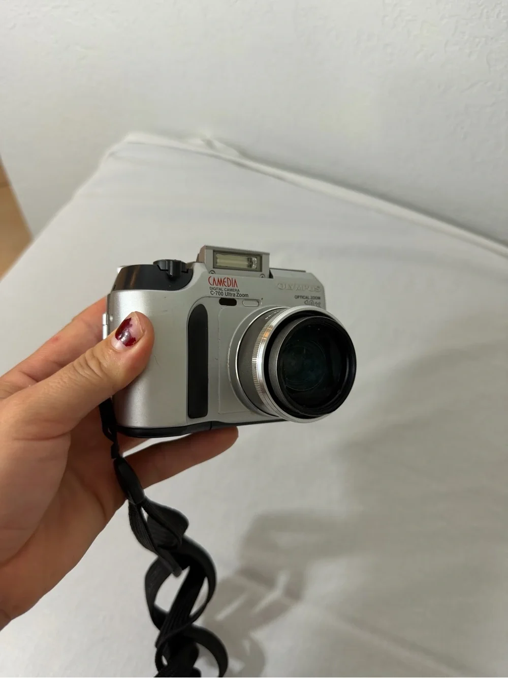 Olympus Silver Compact Digital Camera with Black Wrist Strap